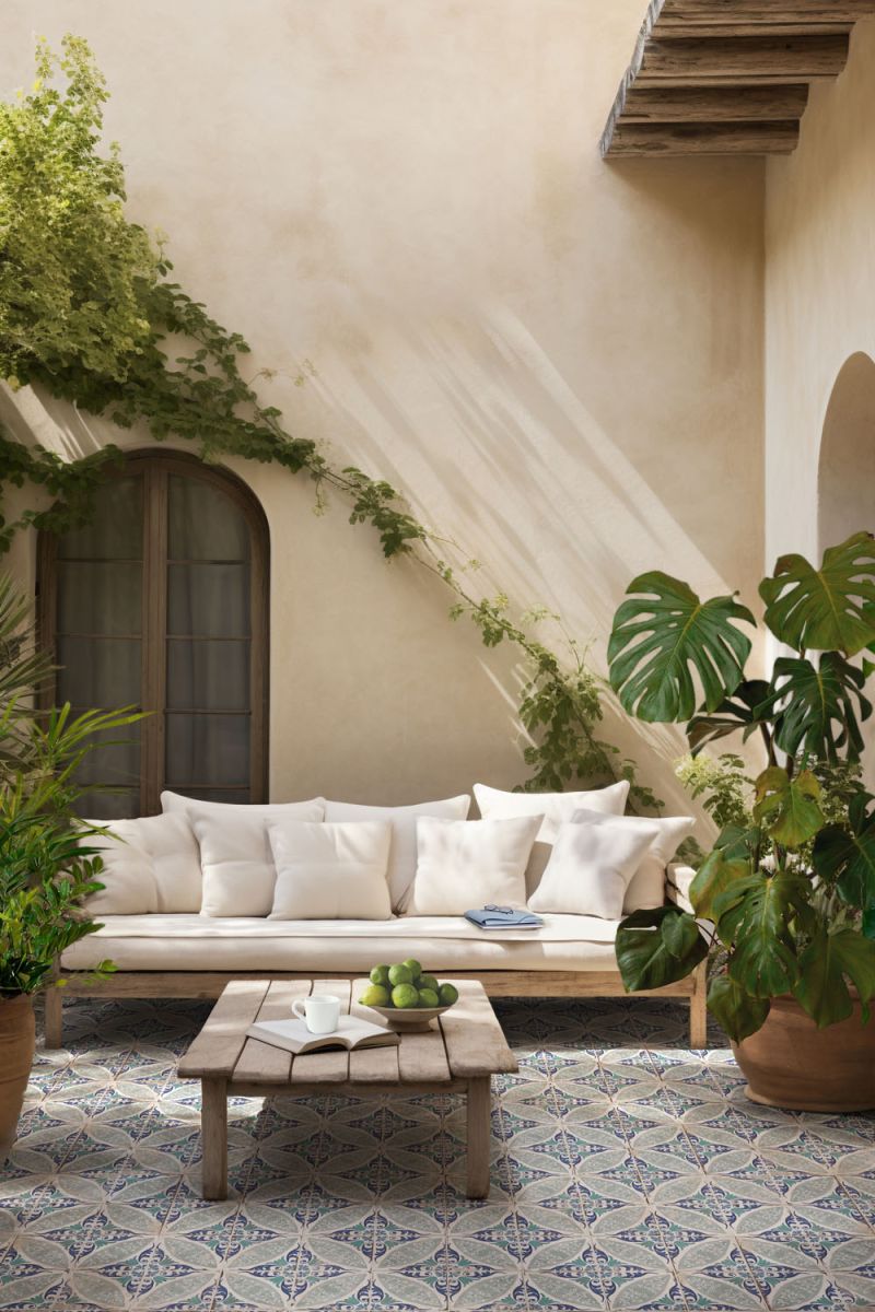 Mediterranean tile soft pattern and muted blue-green palette Magnolia Paulina in a sunlit courtyard