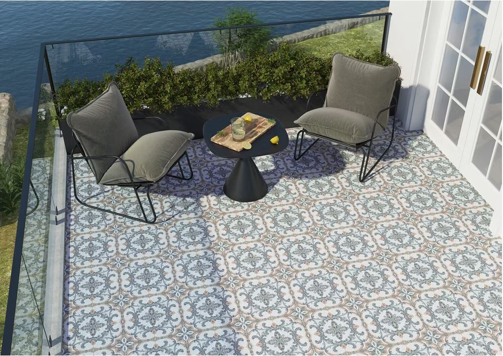 Outdoor patio with chairs and table showcasing Versailles Ezio patterned tiles in grey, white and tan mosaic styling on the floor